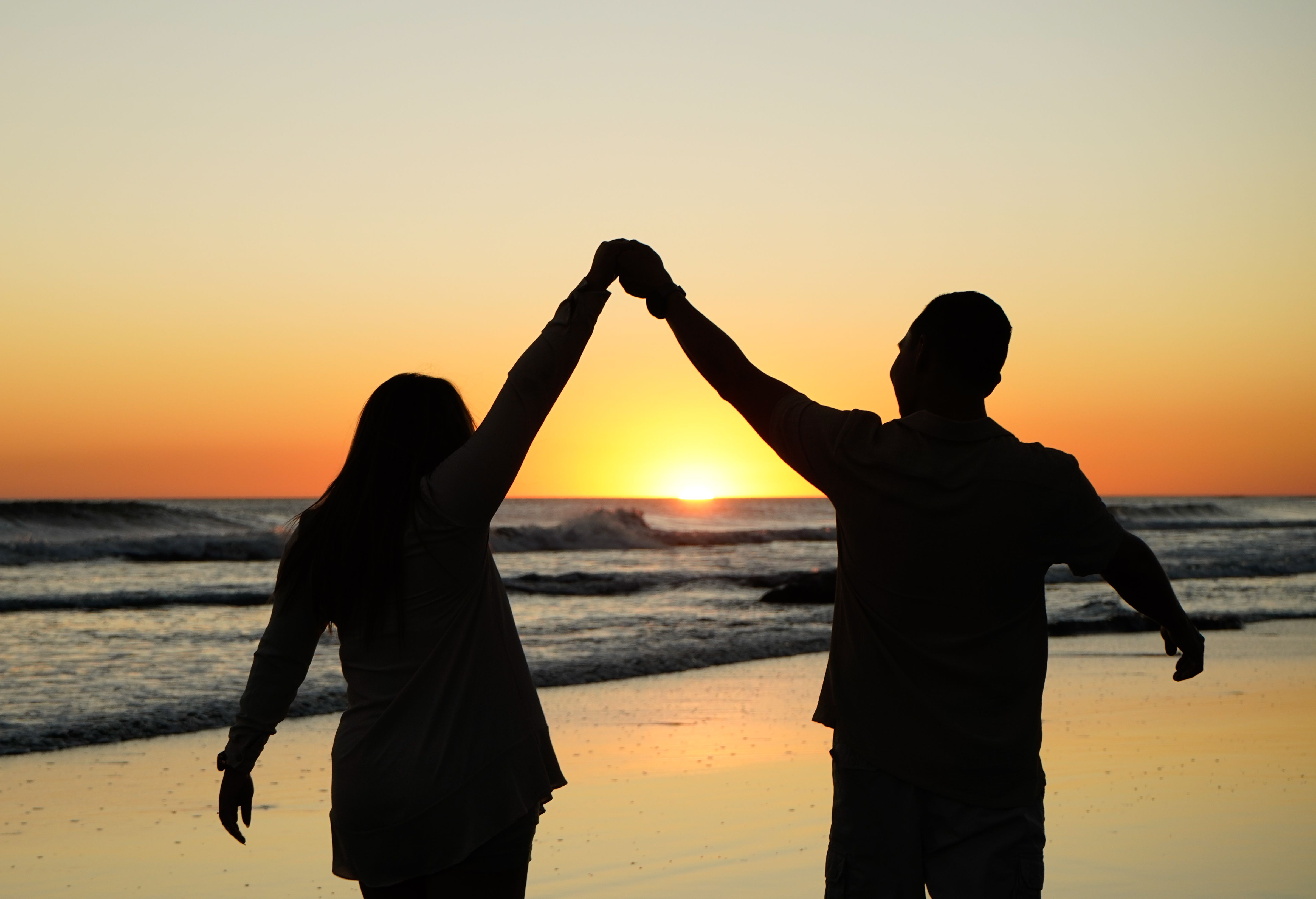 People supporting one another at sunset
